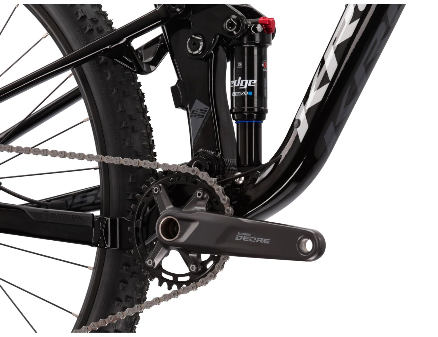  Tylny amortyzator SR Suntour Edge R oraz mechanizm korbowy Shimano Deore M5100 w rowerze górskim MTB XC KROSS Earth 1.0 